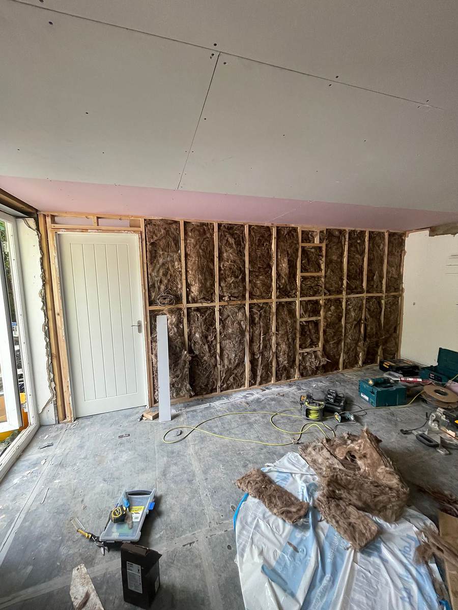Studwork and insulation going in during a Hertfordshire house renovation